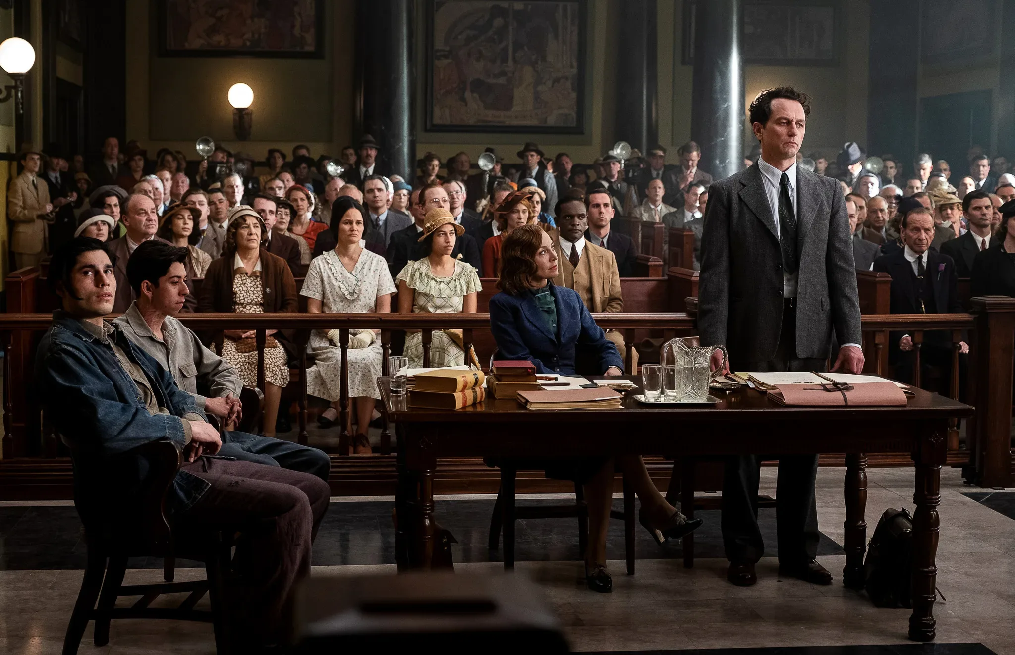 A group of people sitting in a courtroom.